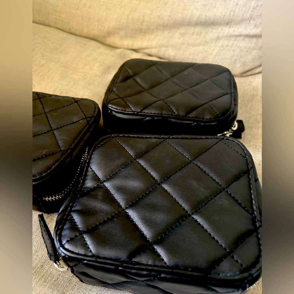 3 used Trish McEvoy quilted makeup planner. Used, some makeup stains. No rips.